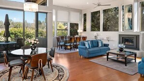 A spacious living room with a fireplace, large windows, and a dining area. - Lux 2-King Suite Luxury Townhome! Pool + Hot Tub! (Sedona)
