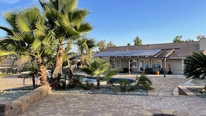 A house with a solar panel roof, a swimming pool, and a fire pit. - Spacious and Private Vacation Rentals in Poway CA. (Poway)