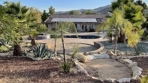 A house with a swimming pool, surrounded by desert plants and a mountainous backdrop. - Spacious and Private Vacation Rentals in Poway CA. (Poway)