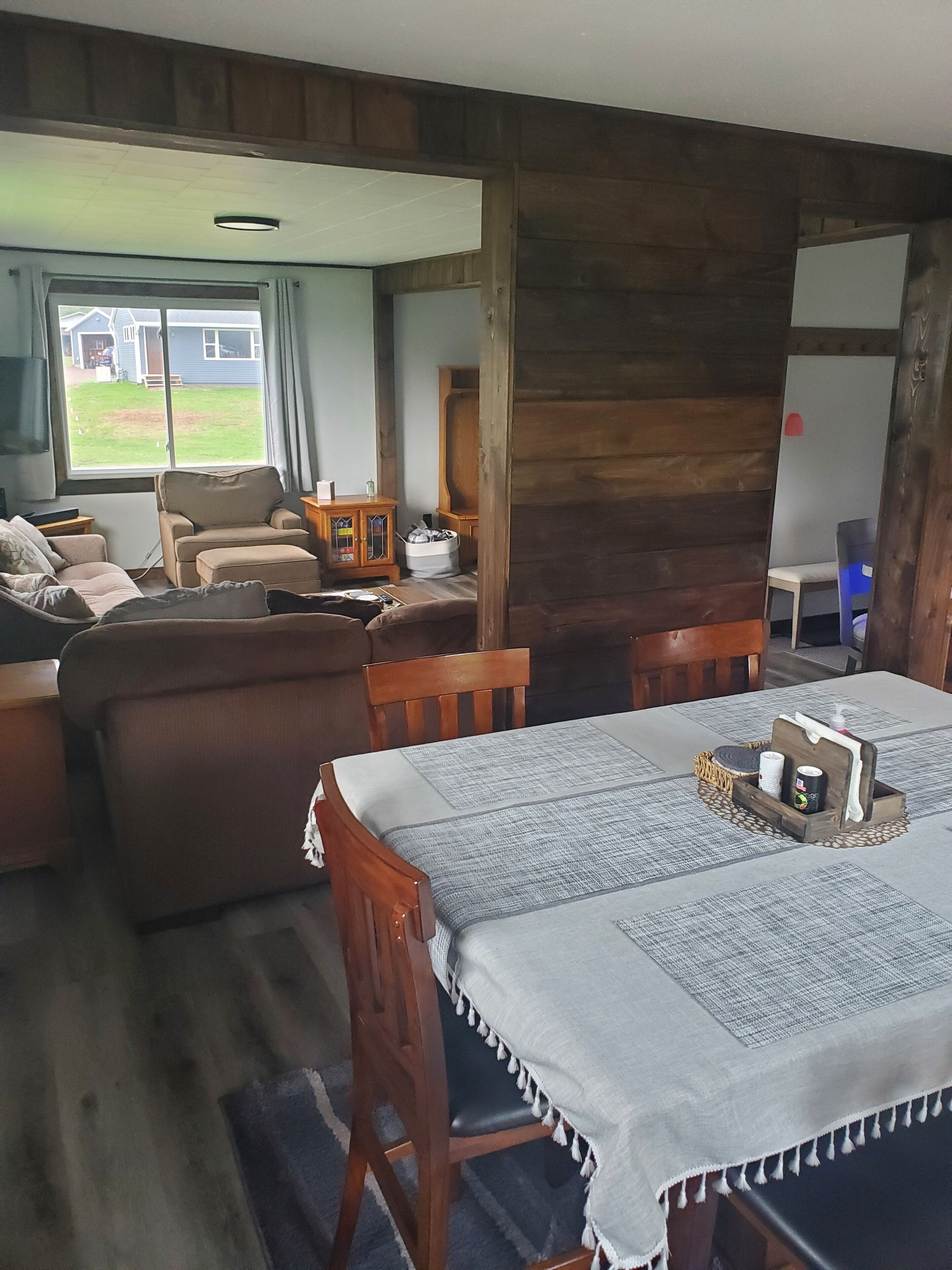 Una habitación acogedora con una mesa de comedor de madera, un sofá y una televisión.