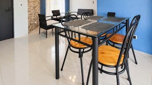 A modern dining area with a glass-top table, black chairs, a ceiling fan, and a clock on the wall. - Mountain views and beautiful sunrises 🗻 (San Ramon)