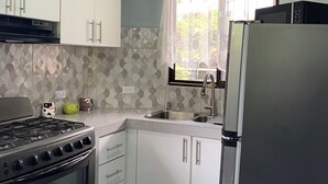 A kitchen with white cabinets, a stove, a sink, and a refrigerator. - Mountain views and beautiful sunrises 🗻 (San Ramon)