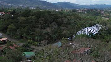 A mountainous landscape with scattered houses and a large white structure.