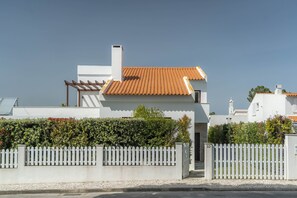 A modern house with a tiled roof, white walls, and a white picket fence. - LV Premier LA2 heated pool, AC, garden, sea view (Sesimbra)