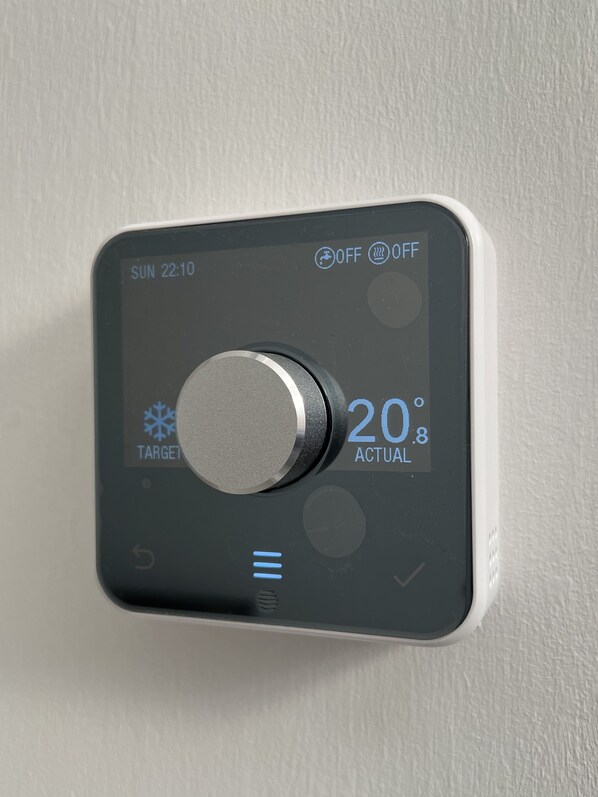 A thermostat with a target temperature setting, current temperature, and a power switch.