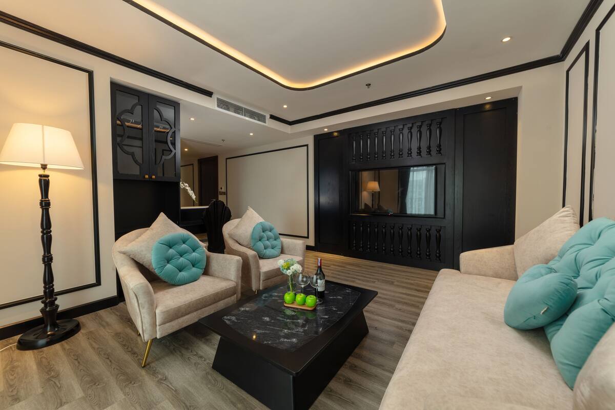 A modern living room with a sofa, armchairs, and a coffee table.