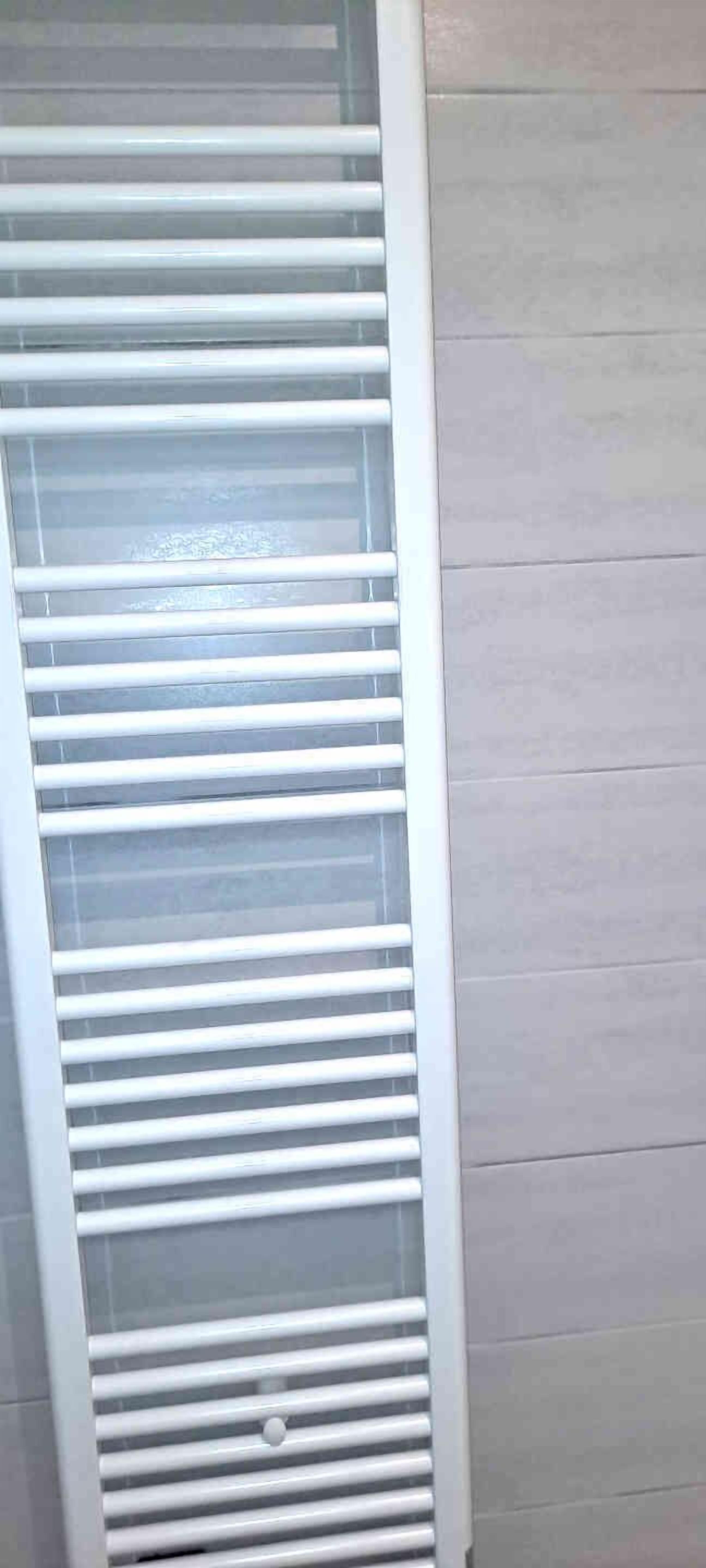 A room with a built-in air conditioning unit with horizontal slats.