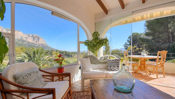 A cozy patio with a wicker chair, a wooden table, and a white sofa. - Ladera - Jesus Pobre, Costa Blanca (Jesus Pobre)