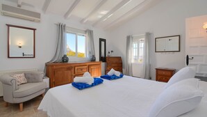 A bedroom with a large bed, a wooden dresser, a sofa, and a window with curtains. - Ladera - Jesus Pobre, Costa Blanca (Jesus Pobre)