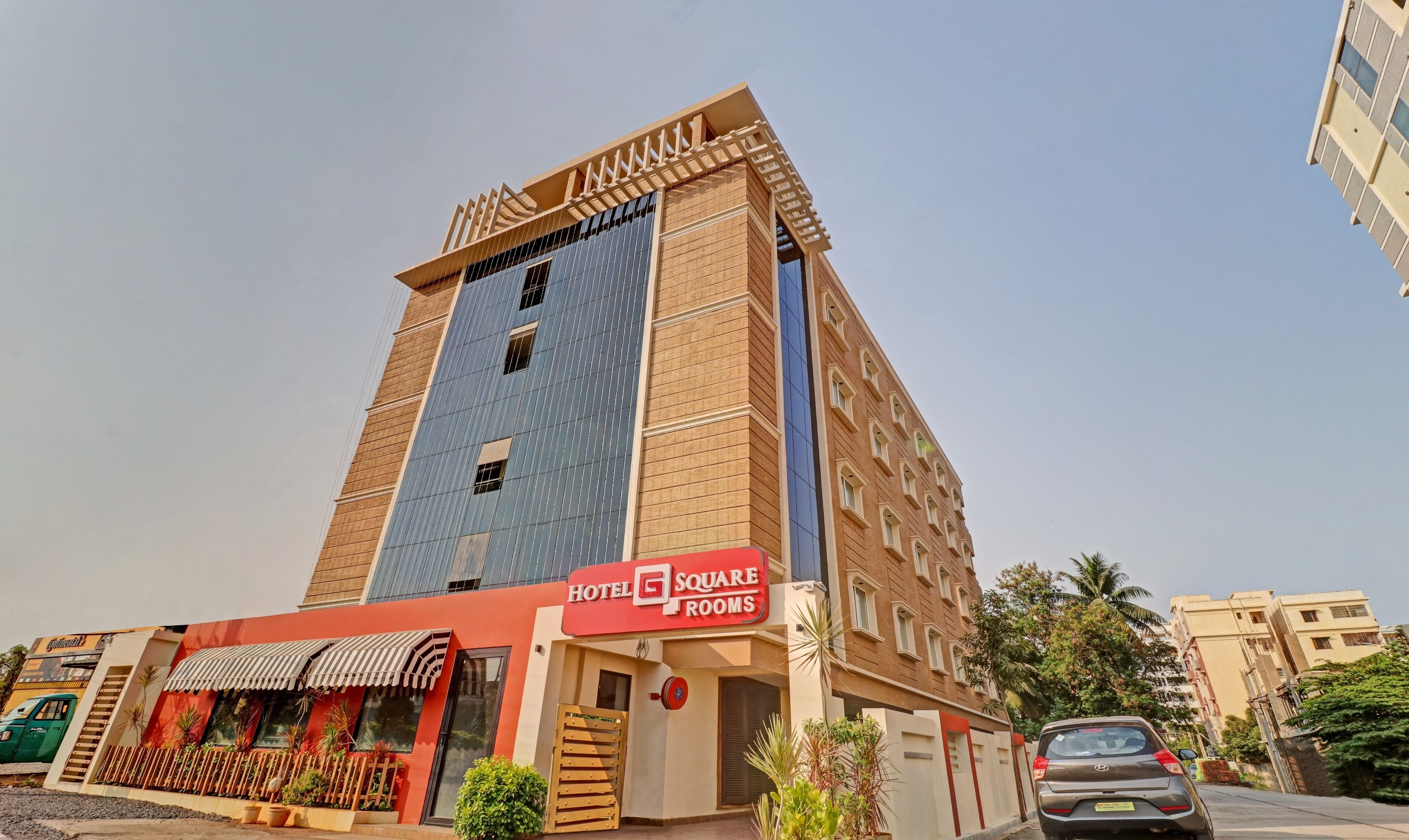 A multi-story building with a sign for "Hotel Square Rooms" indicating a hotel establishment.