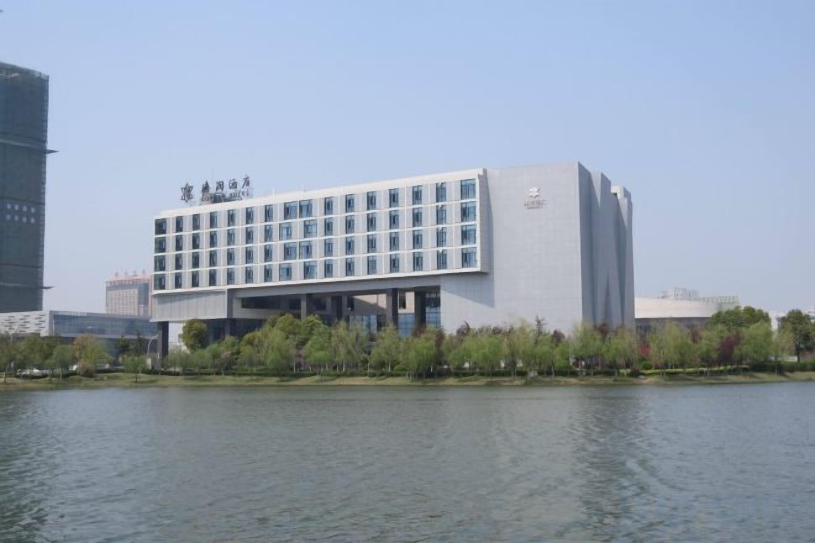 A modern building with a flat roof and a series of windows.
