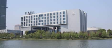 A modern building with a flat roof and a series of windows.