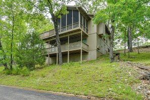 A multi-story building with balconies, surrounded by trees and grassy terrain. - Hot Tub! Golfer's Oasis in Margaritaville Resort (Osage Beach)