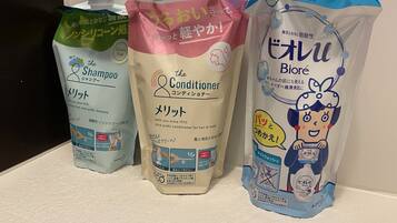 Three bottles of hair care products on a shelf.