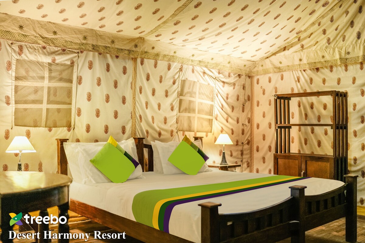 A room with a bed, two bedside tables, and a nightstand.