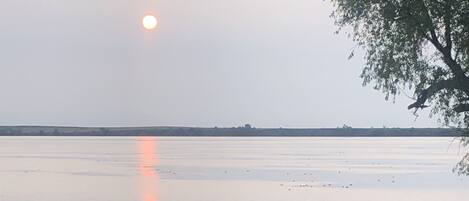A calm lake with a wooden dock extending into the water.