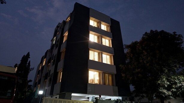 A multi-story building with illuminated windows, likely a hotel or apartment complex. - Treebo Diamond Residency - DDPK Inn (Pune)