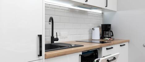 Fridge, stovetop, dishwasher, coffee/tea maker