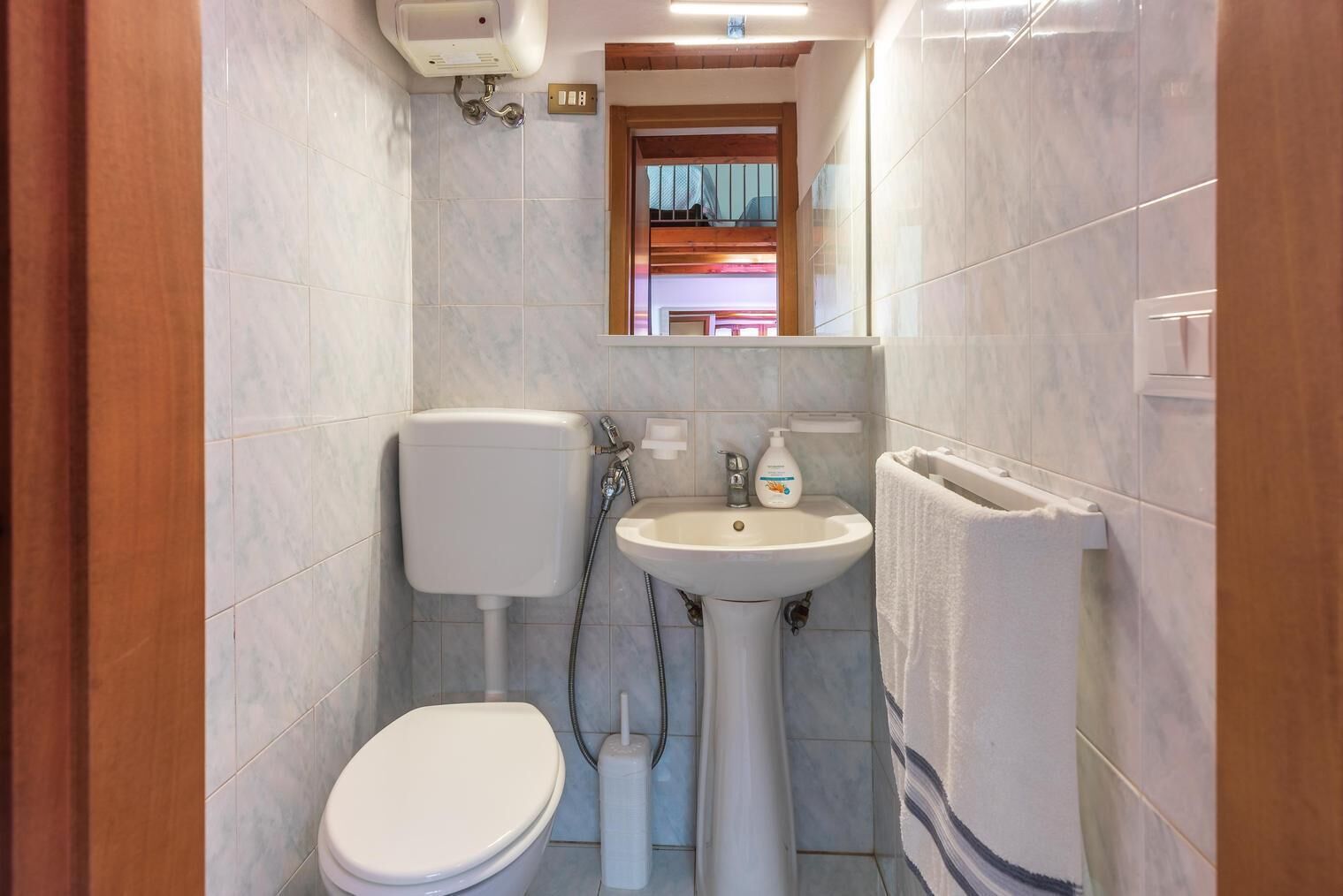 Un bagno piccolo ma funzionale, con il water, il lavandino e la doccia.