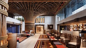 A spacious lobby with a high ceiling, bamboo columns, and a bar area with a variety of bottles. - Mandala Hotel & Spa Phu Yen - 24-hour stay (Tuy Hoa)