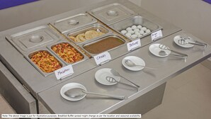 A buffet with labeled food sections including Macaroni, Chowley, and Boiled Eggs. - Treebo Sidhartha Elite (Bhubaneshwar)