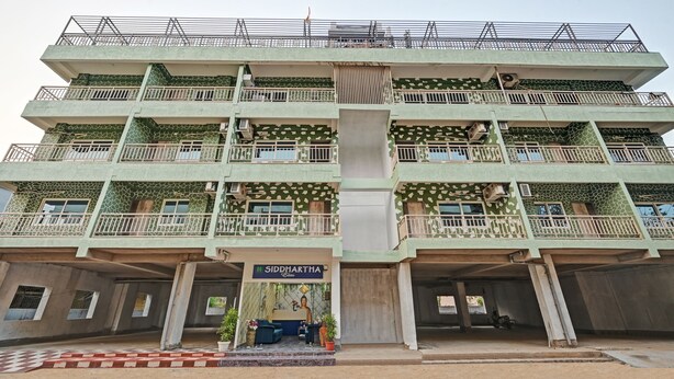 A multi-story building with balconies, air conditioning units, and a sign for Siddhartha Elite. - Treebo Sidhartha Elite (Bhubaneshwar)