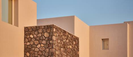 A modern building with a stone facade and arched openings.