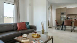 A modern living room with a sofa, coffee table, and dining area. - Villa Dora - Apartment 4 "Brown" with balcony (Pula)