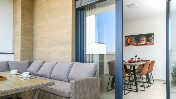 A modern living area with a sofa, dining table, and chairs. - Villa Dora - Apartment 4 "Brown" with balcony (Pula)