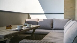A cozy seating area with a wicker table, cushions, and a cup of tea. - Villa Dora - Apartment 4 "Brown" with balcony (Pula)