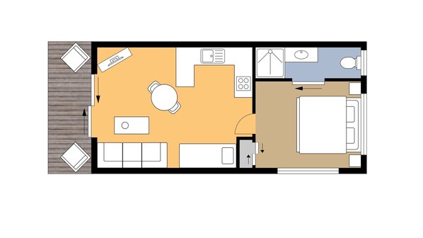 A hotel room layout with a bed, a desk, a chair, a small table, and a window.