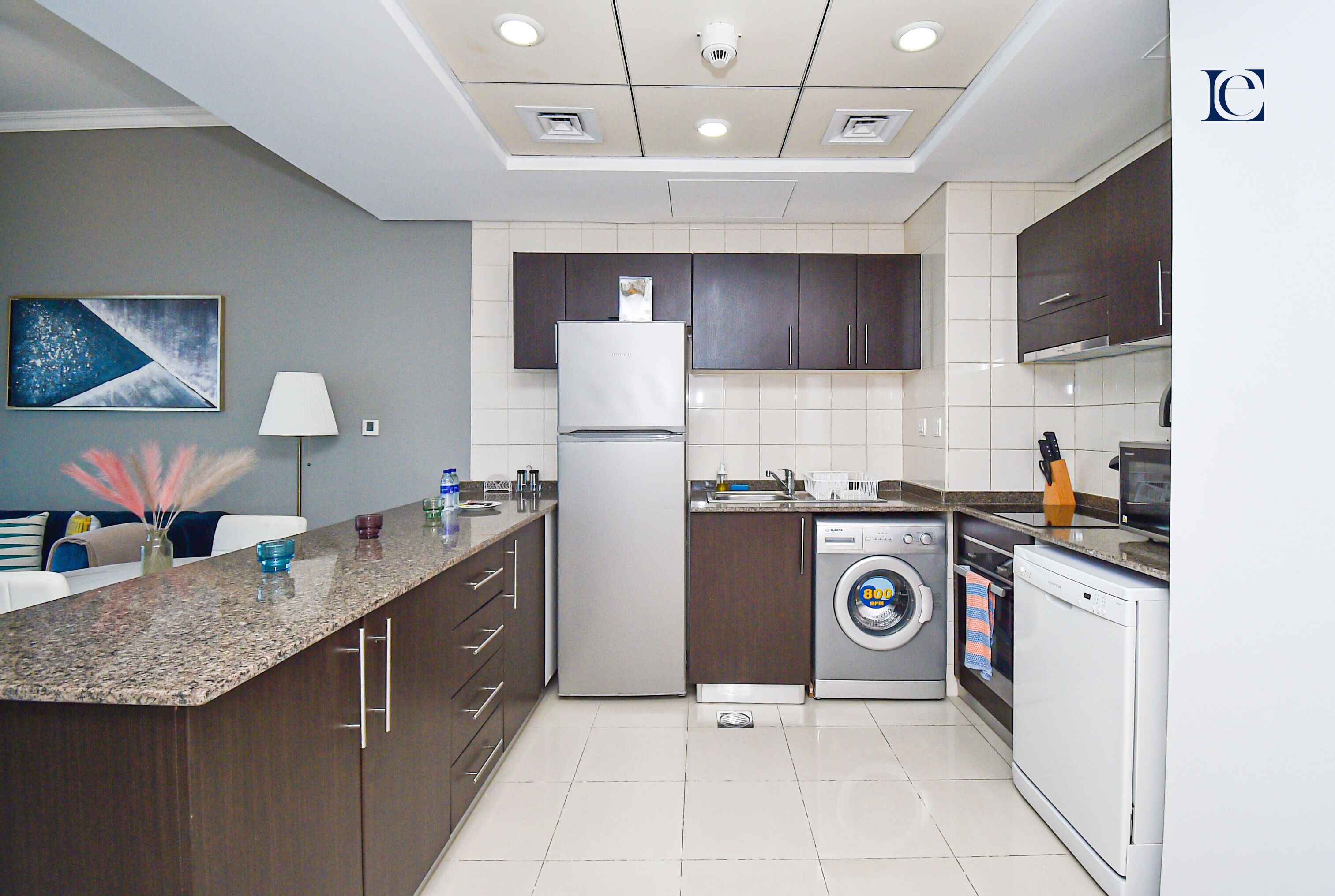 A modern kitchen with a refrigerator, dishwasher, and microwave.