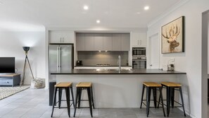 Enjoy cooking in this well-lit kitchen with a central island and stainless steel appliances.