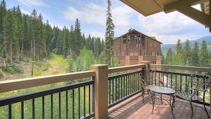 A wooden building with a balcony, a table, and chairs. - Luxurious 2 Br In River Run Village With Ski In Ski Out, No Cleaning Fees, Kids Ski Free 2 Bedroom Condo by RedAwning (Keystone)