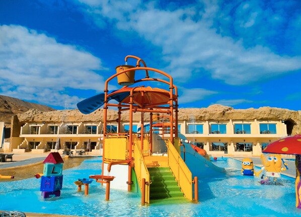 A water park with a slide, play structures, and a pool. - Elgalala Aqua Park (Ataqah)