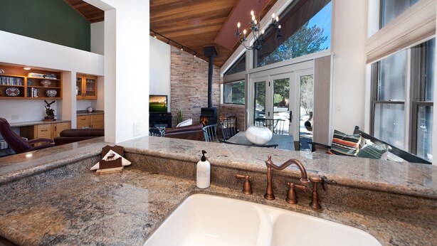 A modern kitchen with granite countertops, copper faucets, and a built-in stove. - Hermosa Haven | Red Cliff Views, Garage, 30+ Stay (Durango)