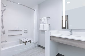 A modern bathroom with a bathtub, shower, and sink. - Holiday Inn Express & Suites Dallas – Plano North by IHG (Plano)