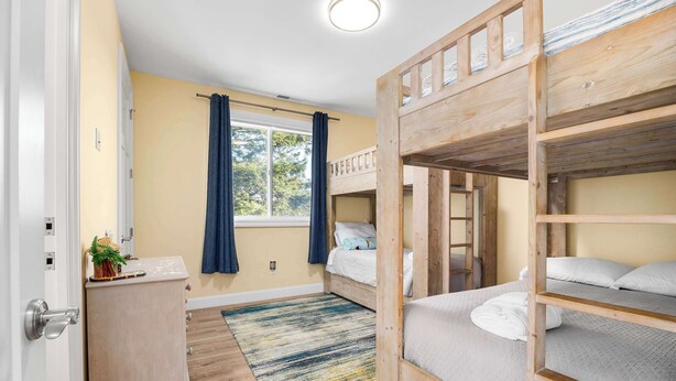 A bunk bed room with a window, a desk, and a rug. - Oceanfront Beach House overlooking the Boardwalk (Santa Cruz)