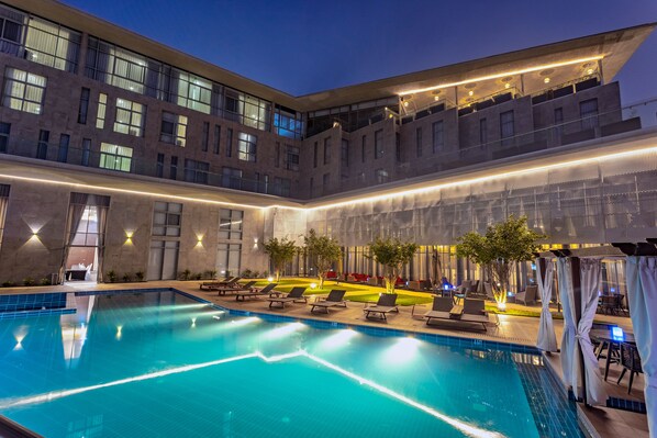Outdoor pool, open 6:00 AM to 6:00 PM, free cabanas, pool umbrellas