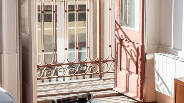 A staircase with a wrought iron railing leading to a balcony. - Aurora Heights Apartment by LovelyStay (Porto)