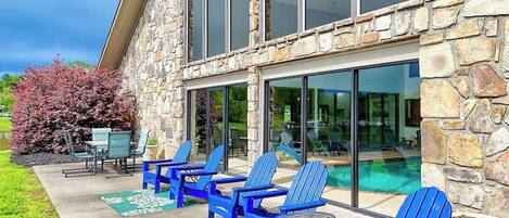 A stone building with a pool and outdoor seating area.