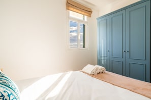 Cozy retreat with a single bed, white bedspread, and a neatly folded towel.