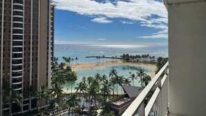 A hotel with a view of a beach and a pool area. - Resort Style with Hula Show, Fireworks and even Tiki Torches! (Honolulu)