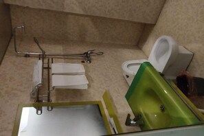 A bathroom with a green sink, a white toilet, and a grab bar. - Nanchang Jindi Hotel (Bayiguan Subway Station Branch) (Nanchang)
