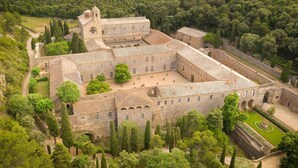 An aerial view of a historic stone building with multiple courtyards, surrounded by lush greenery and a forested hillside. - Luxurious Mas with Bassin Balnéo Sea View in Collioure 12 pers (Collioure)