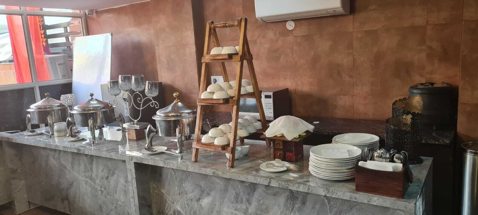 A kitchen counter with various kitchenware, including pots, pans, and a wooden stand holding bowls.