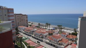 A coastal residential area with buildings, a beach, and a clear view of the sea. - SHR019 Gran Atico al lado de la playa (Torrox Costa)