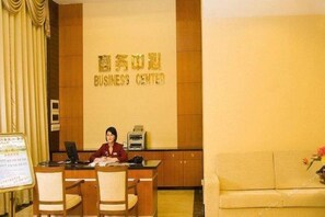 A reception desk with a sign reading 'BUSINESS CENTER' in a hotel lobby. - Hotel Fisher (Guangzhou)