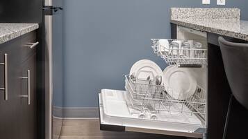 Full-sized fridge, stovetop, dishwasher, coffee/tea maker