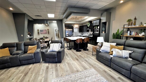 A spacious living room with a dining area, kitchen, and a small office space. - Adorable 7 bedroom place (Mitchell)